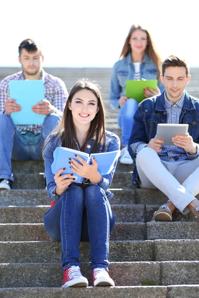 depositphotos_47964539-stock-photo-happy-students-sitting-on-stairs