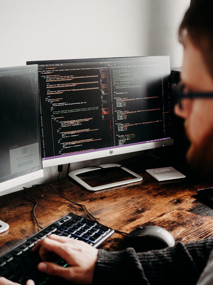 zipwp-image-16129728 Man Coding on PC